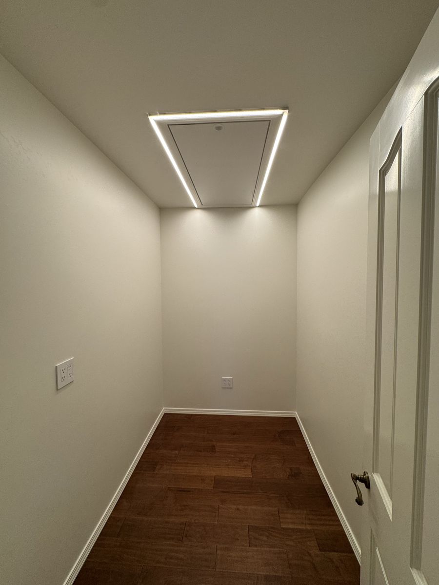 Custom LED tape lighting fixture framing a pantry ceiling hatch